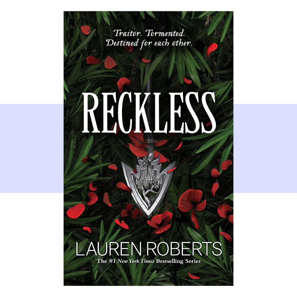 Book cover for Reckless by Lauren Roberts. The cover features a deep forest-green and nearly black background, layered with long, pointed green leaves and scattered vivid red petals. A silver dagger-shaped pendant hangs vertically in the center, its ornate handle and blade creating a striking focal point beneath the title. “RECKLESS” appears across the upper-middle area in very large, tall white serif capital letters. Above the title, smaller white text reads, “Traitor. Tormented. Destined for each other.”